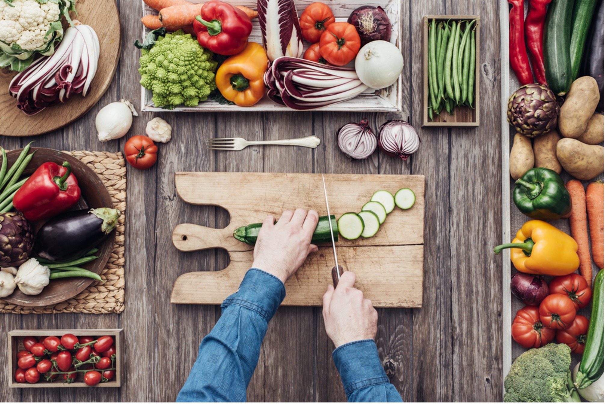 cutting cucumber with other fruits and vergetables